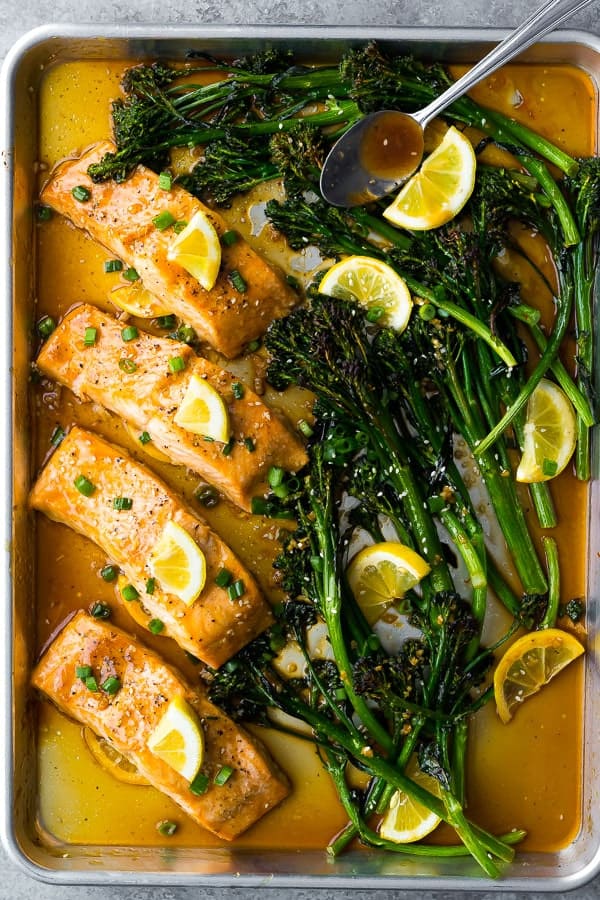 overhead shot of Sheet Pan Honey Lemon Salmon & Broccolini after baking with spoon