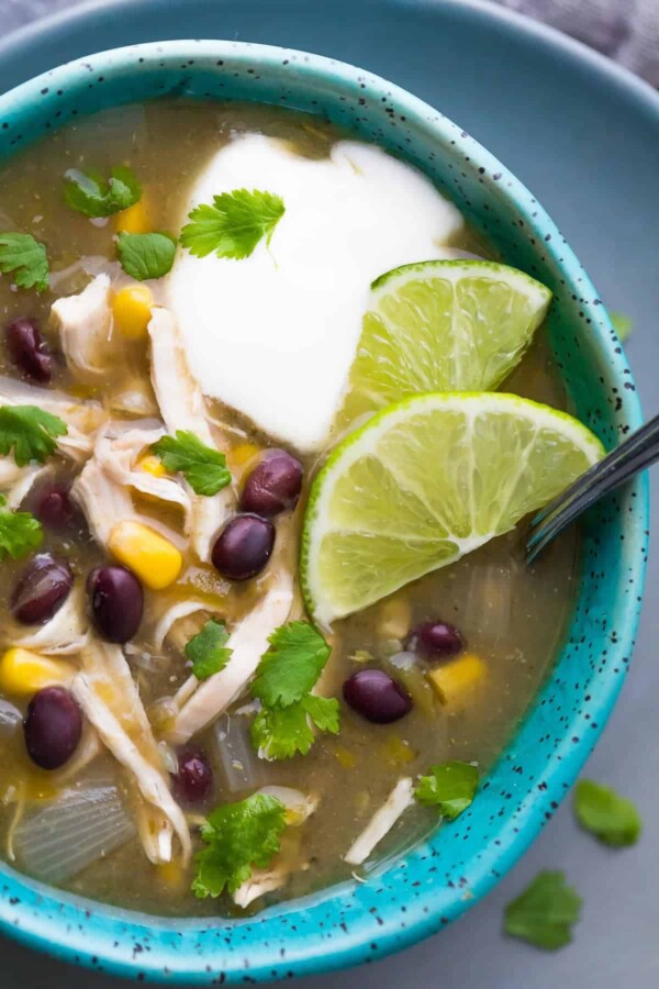 Shortcut Instant Pot Chicken Chile Verde Soup in blue bowl and lime wedges
