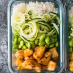 overhead shot of firecracker chicken meal prep bowl in glass container