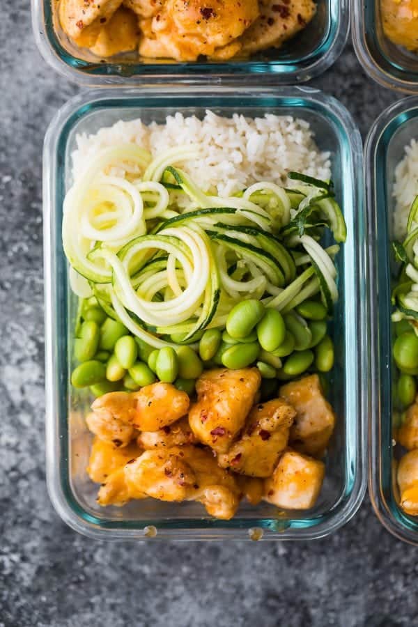 overhead shot of firecracker chicken meal prep bowl in glass container