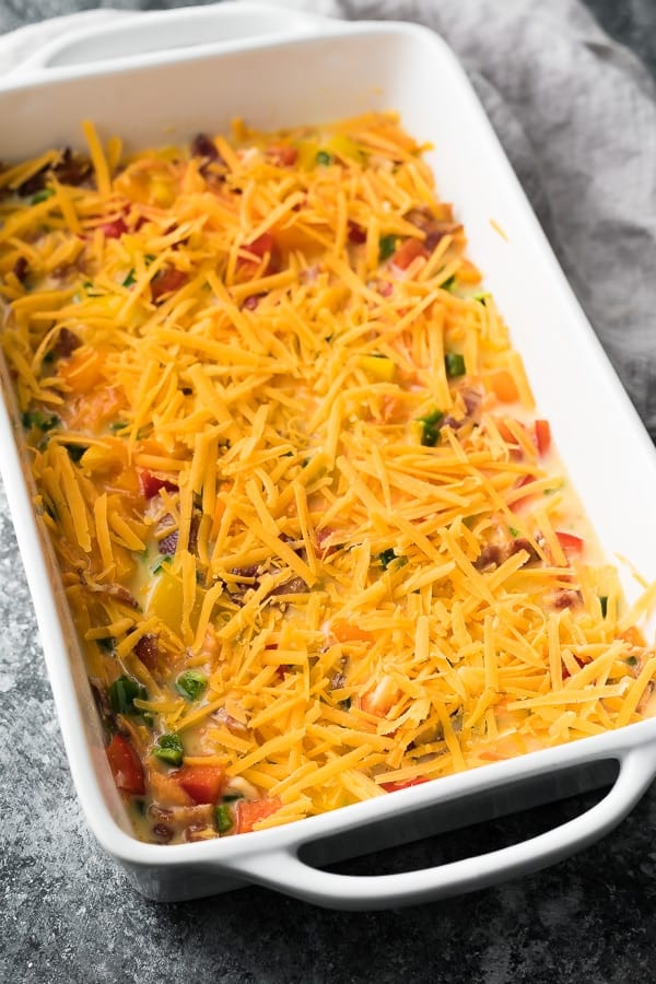 cheese sprinkled on the Overnight Breakfast Casserole with Bacon and Sweet Potato Hash Browns