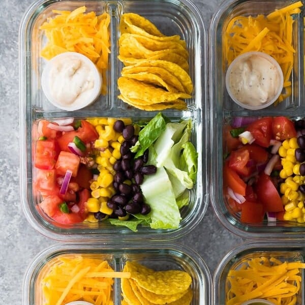 overhead shot of taco salad bento lunch boxes in glass containers