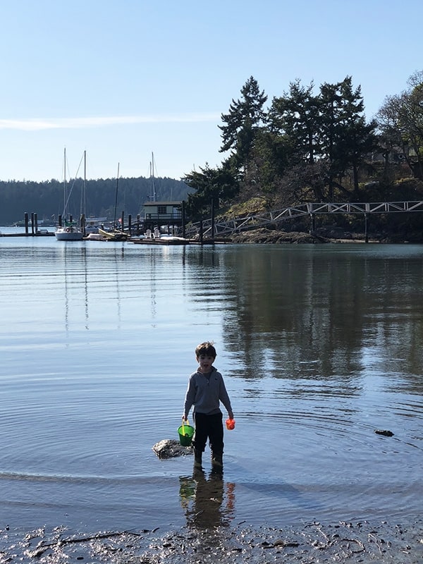 a boy standing in the water