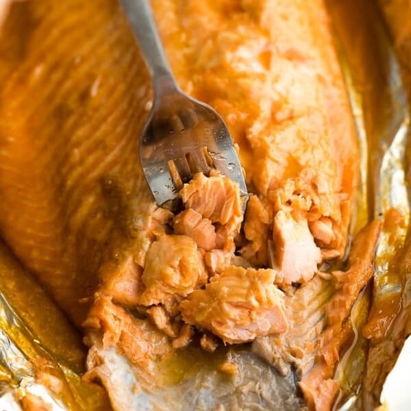 a fork flaking the maple glazed salmon