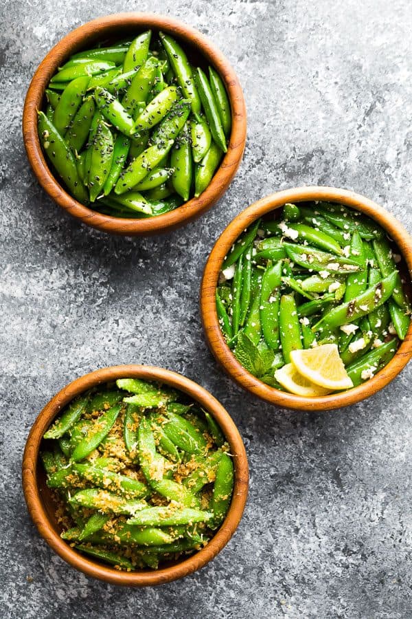 overhead shot of three brown bowls filled with sugar snap peas in various recipes