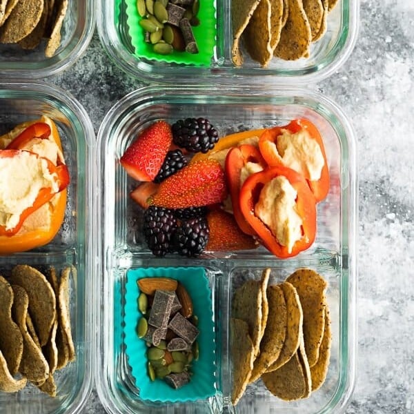 overhead shot of vegan bento snack boxes in glass meal prep container