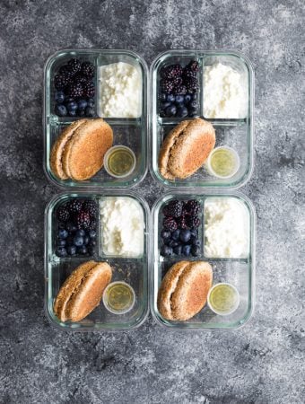 overhead shot of four english muffin breakfast bento boxes on gray background