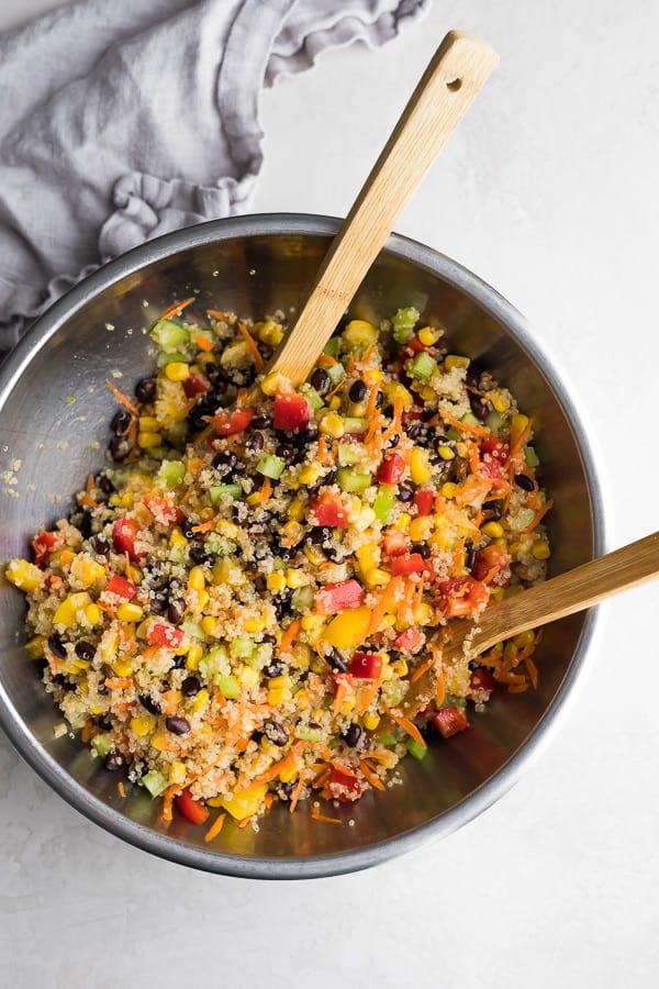 quinoa black bean salad in bowl with spoons