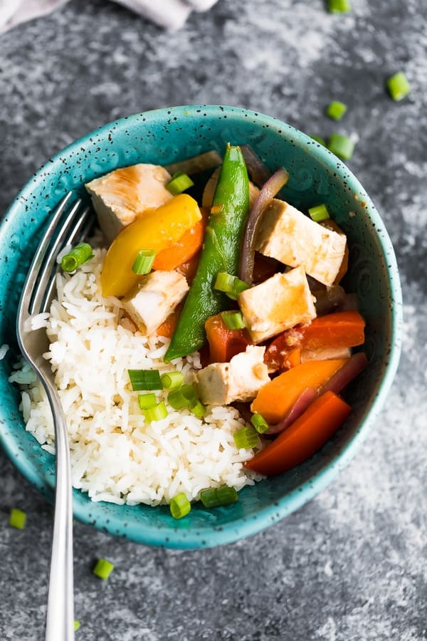 Instant Pot Coconut Sweet Chili Chicken Stir Fry in blue bowl with fork
