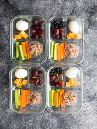 overhead shot of four tuna protein bistro boxes including grapes, egg, cheese, and veggie sticks