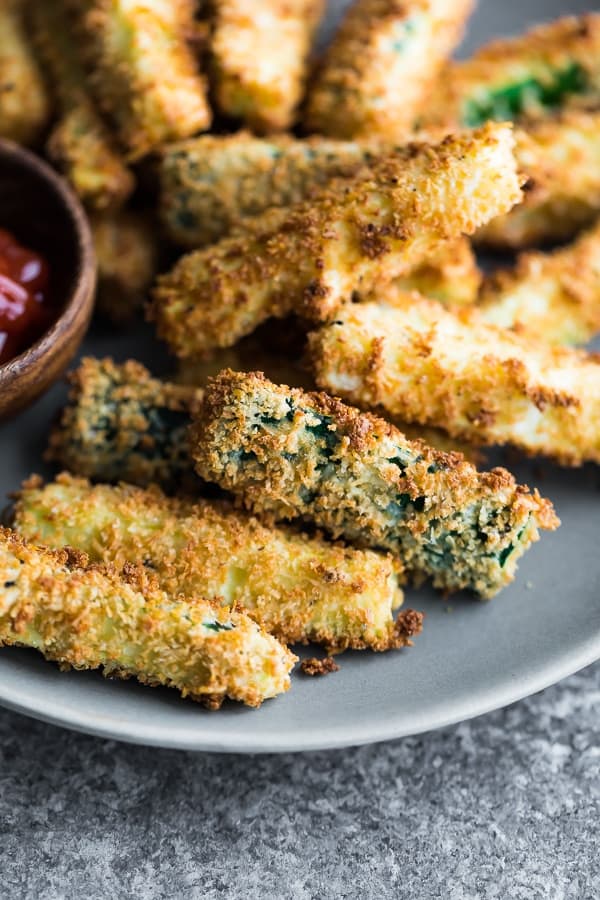 close-up of Air Fryer Zucchini Fries arranged on a plate with ketchup