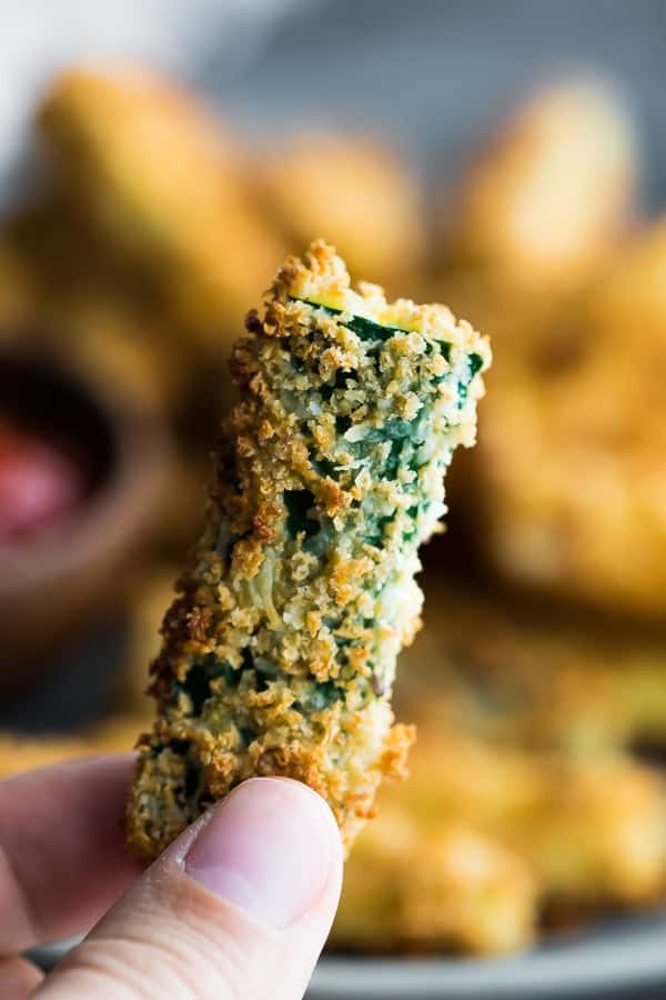 hand holding an air fryer zucchini fry