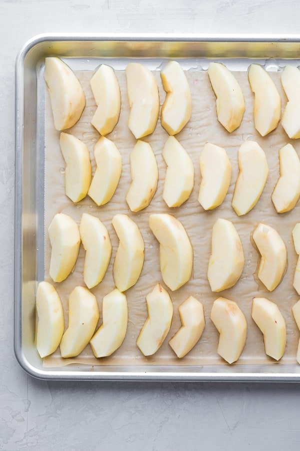 frozen apple slices on baking sheet