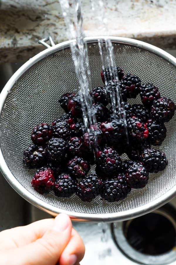 How to Freeze Blackberries: rinsing blackberries under tap water