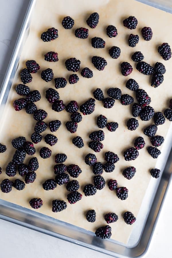 How to Freeze Blackberries: washed and dried blackberries arranged on a baking sheet