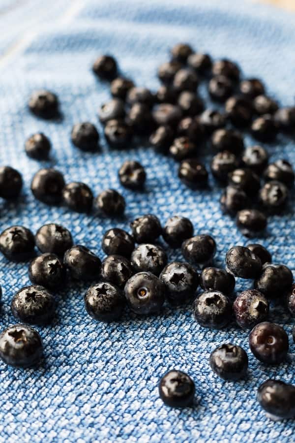 blueberries drying on a blue cloth