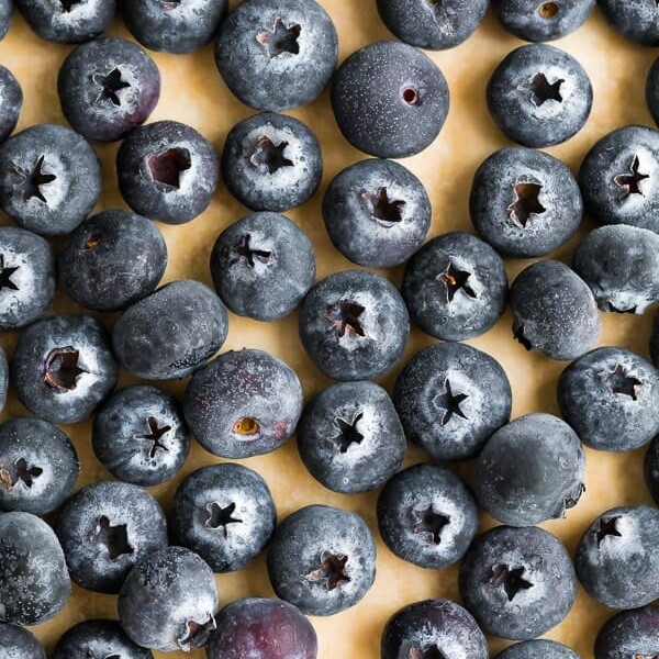 overhead shot of lots of blueberries on wood cutting board