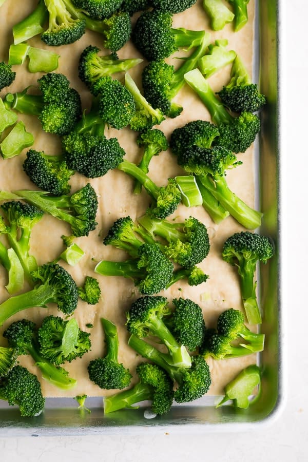 close up view of broccoli florets on a sheet pan