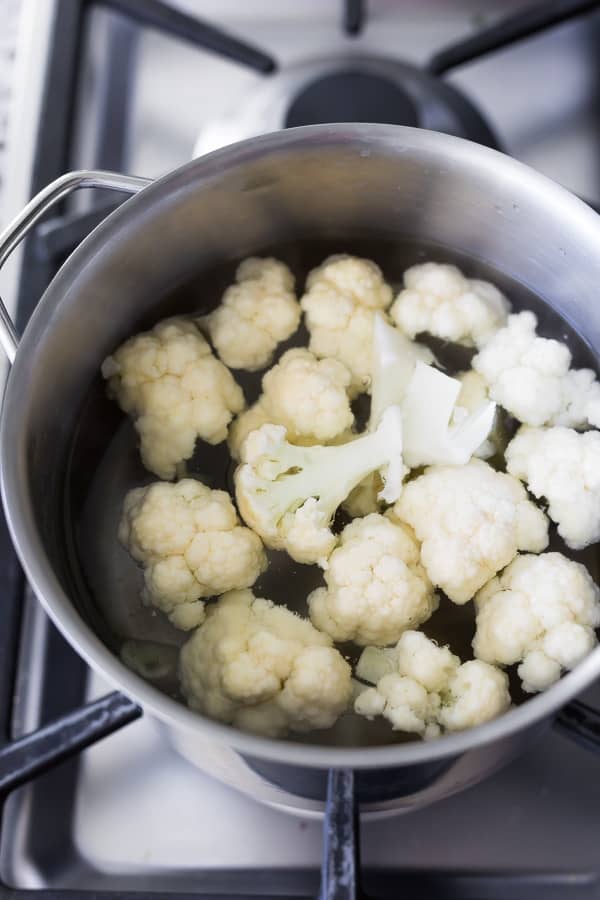 cauliflower florets in pot of water on stove