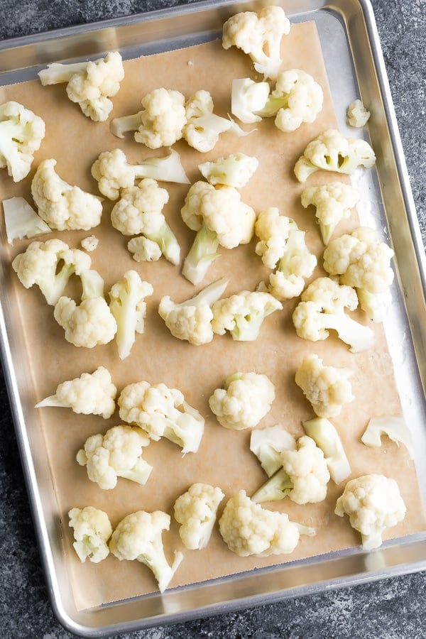 overhead shot of cauliflower florets on a sheet pan