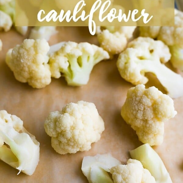 lots of cauliflower sitting on a wood cutting board