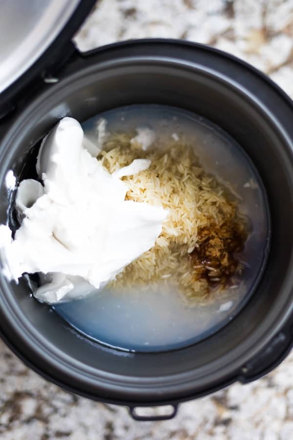 all ingredients for coconut milk rice in a rice cooker before cooking