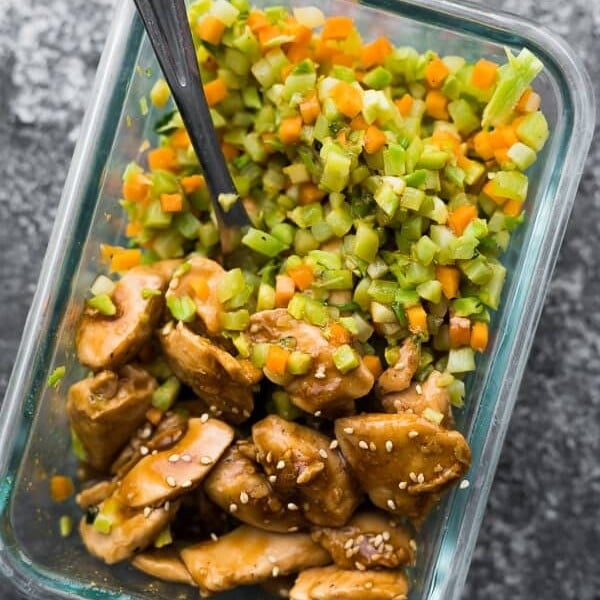 overhead shot of broccoli rice teriyaki chicken with fork in glass container