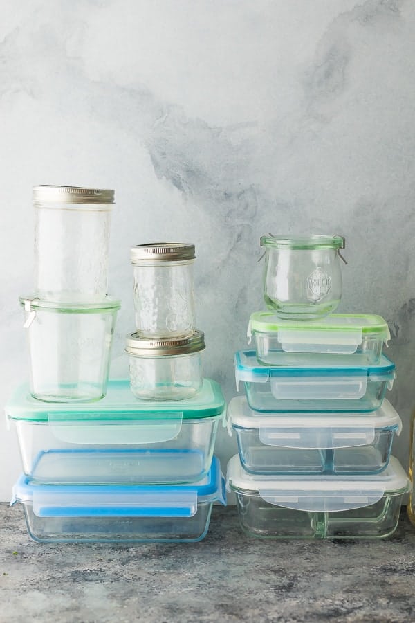 stack of glass meal prep containers and mason jars