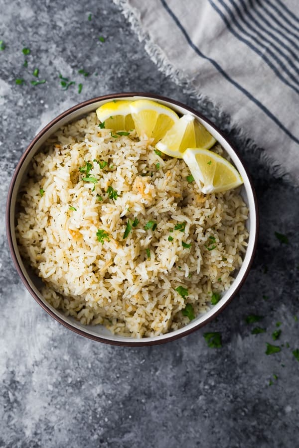 overhead shot of Herb Lemon Rice Recipe in brown bowl with blue striped napkin