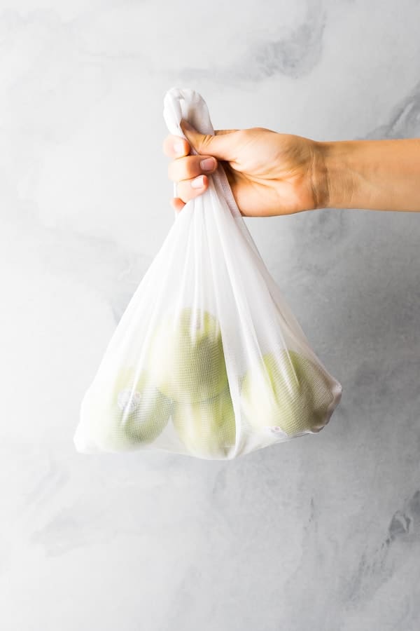 a hand holding up a white plastic bag