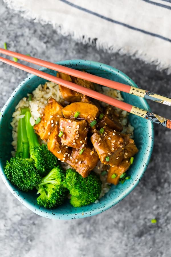 crock pot teriyaki chicken recipe in blue bowl with chopsticks