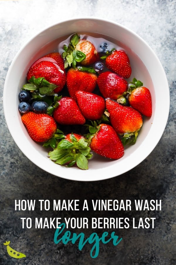 white bowl with fruit and text overlay saying how to make a vinegar wash to make your berries last