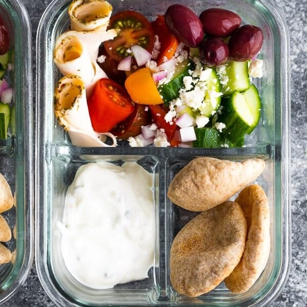 overhead shot of glass meal prep container with no cook greek pita bento and salad