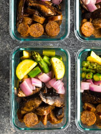 overhead shot of four glass meal prep containers with low carb breakfast bowls