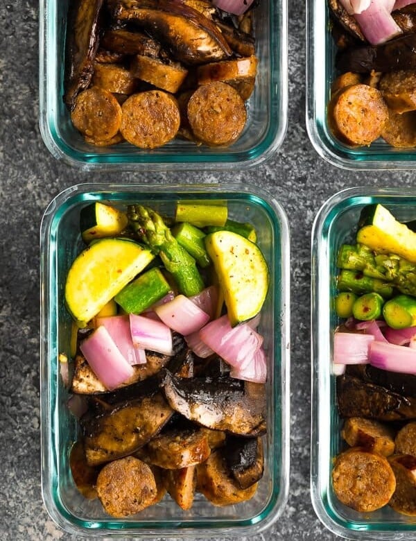 overhead shot of four glass meal prep containers with low carb breakfast bowls