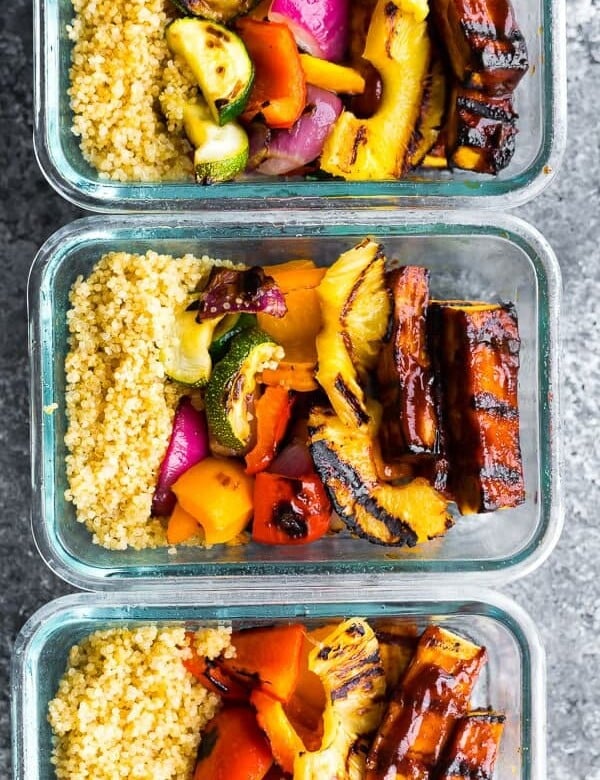 overhead shot of three glass meal prep containers with pineapple bbq tofu