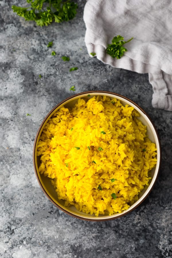 bowl with the turmeric rice on grey background