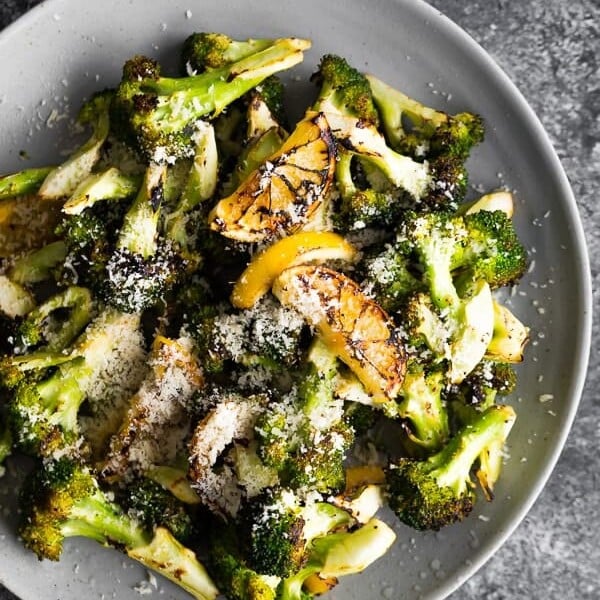Overhead view of Grilled Broccoli with Lemon and Parmesan in a gray bowl
