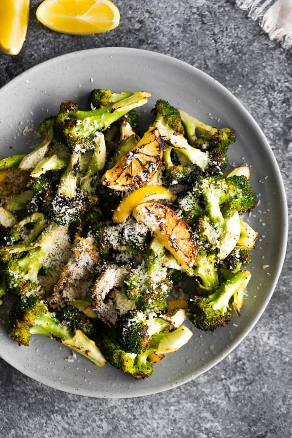 Overhead view of Grilled Broccoli with Lemon and Parmesan in a gray bowl