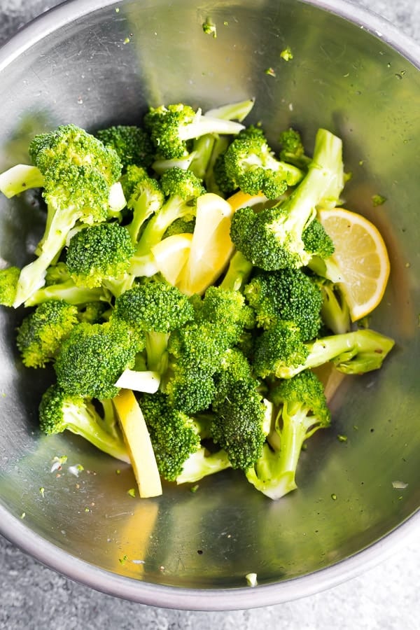 broccoli and lemons in bowl before cooking