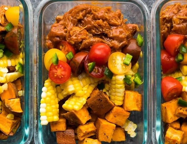 overhead shot of pulled pork meal prep bowls in glass containers