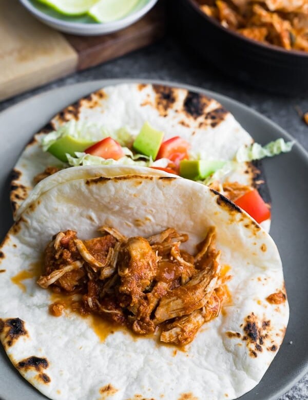 gray plate with salsa chicken in fajitas