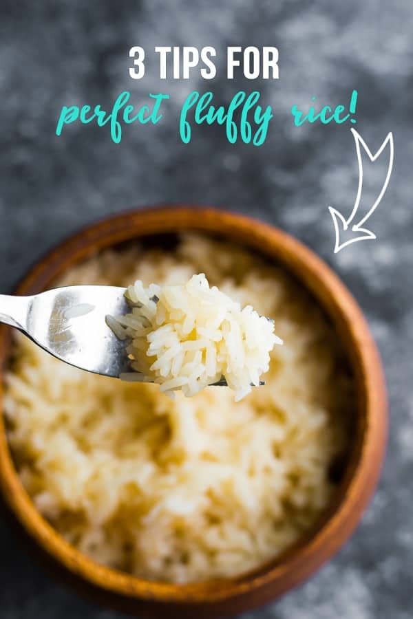 fork holding fluffy long grain white rice