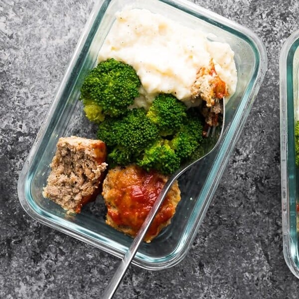 overhead shot of low carb meatloaf and caufliflower mash in glass meal prep container