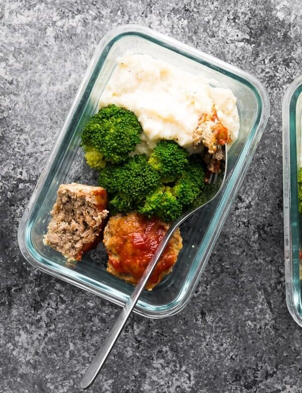 overhead shot of low carb meatloaf and caufliflower mash in glass meal prep container