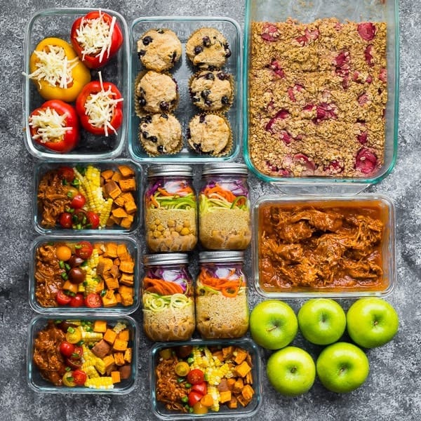 overhead shot of a variety of meal prep lunches in glass jars and meal prep containers