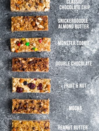 overhead shot of 7 different flavors of homemade granola bars on gray background