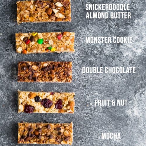 overhead shot of 7 different flavors of homemade granola bars on gray background