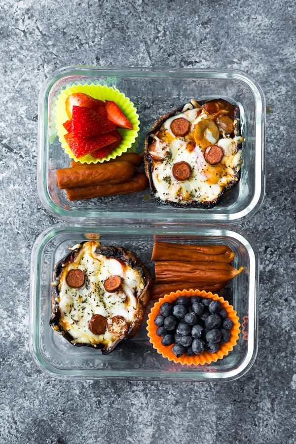 pepperoni pizza stuffed portobello mushrooms in lunchbox with pepperoni sticks and berries