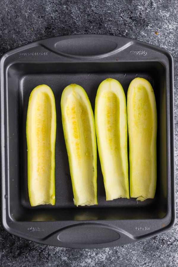 scooped out zucchini in a baking dish